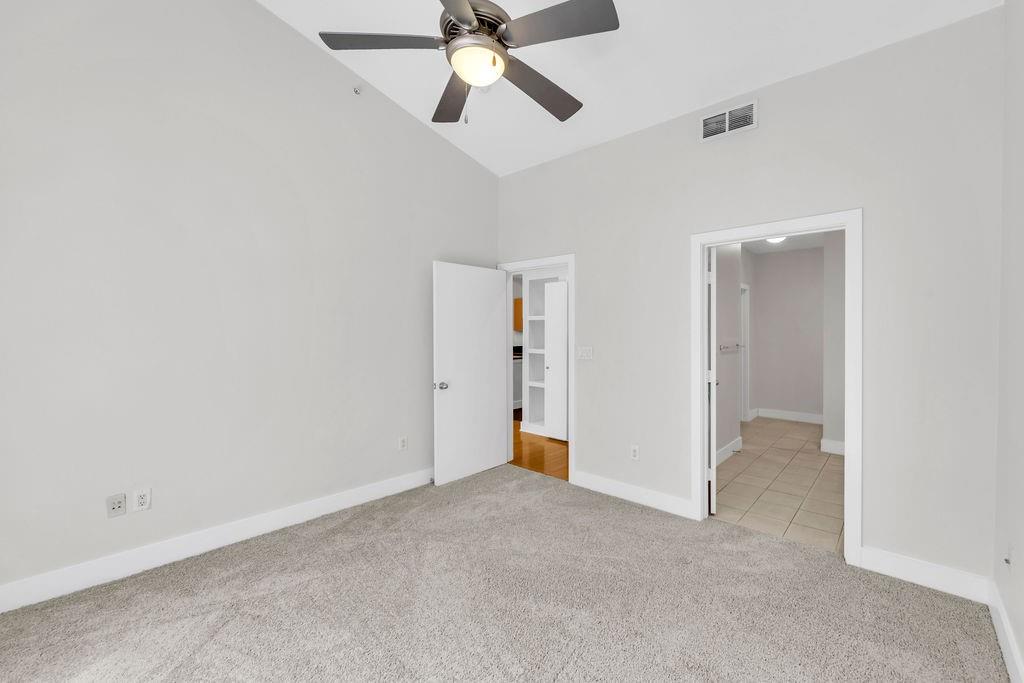 Neutral wall tones, recessed lighting, ceiling fan, and carpeted flooring