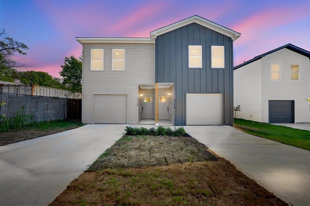 Contemporary exterior with vertical and horizontal siding, individual garages, and concrete driveways