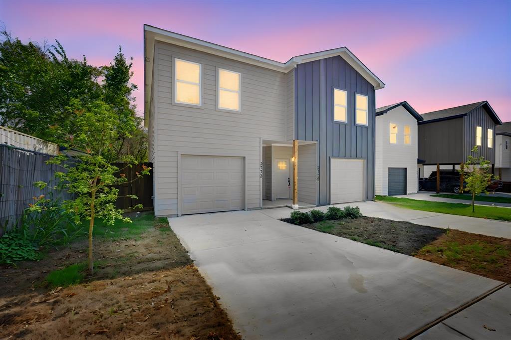 Contemporary architectural design featuring a prominent peaked roofline, a combination of horizontal siding and vertical paneling, an attached garage, a covered entryway with a wooden support beam, and a concrete driveway
