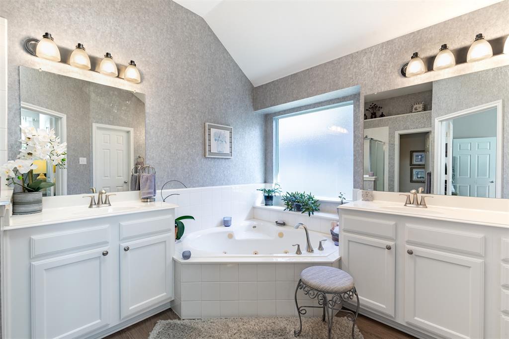 En-suite bath with dual vanities and jetted tub.