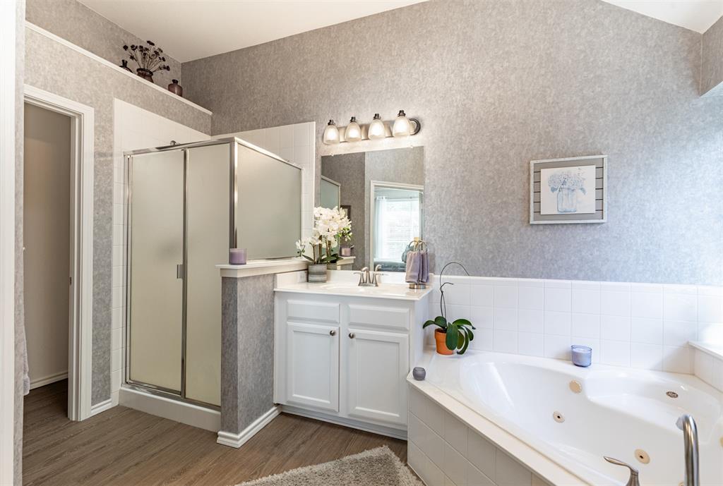 En-suite bath with separate shower and private toilet room.