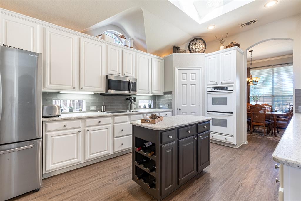 Gourmet kitchen features prep island with wine storage. Gourmet kitchen features prep island with wine storage.