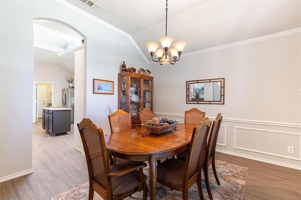 Dining room features chandelier, and access to kitchen.