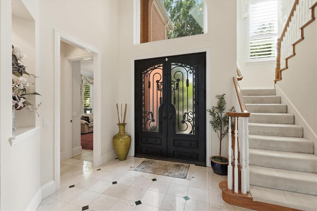 Double wood & iron doors lead into the foyer