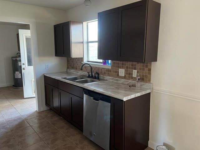 Kitchen featuring dark wood-finish cabinetry, stone-pattern laminate countertops, a mosaic tile backsplash, a dual-basin stainless steel sink with a dark-finish faucet, and a stainless steel dishwasher