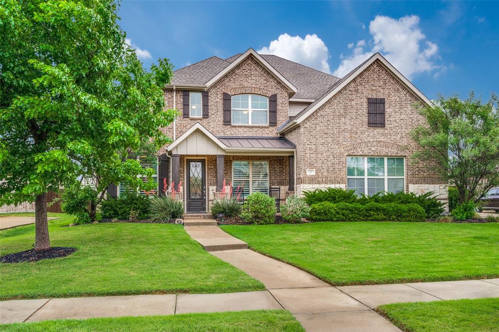 Brick exterior with stone accents and dark shutters