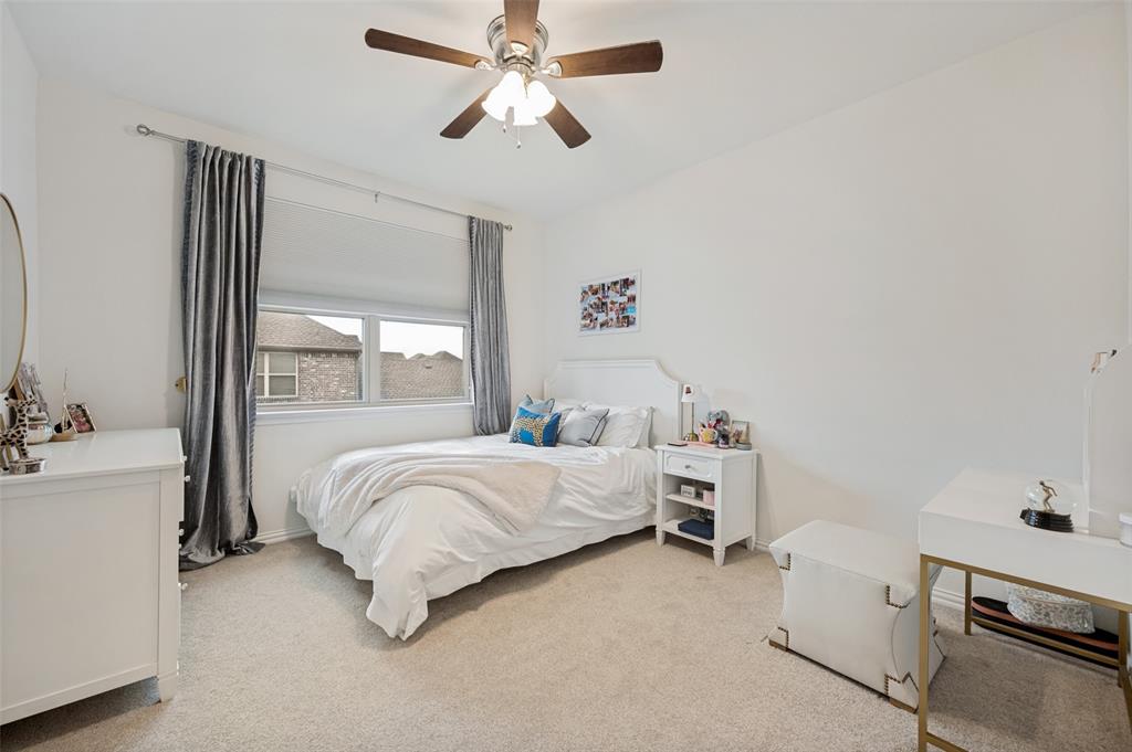 Recessed lighting, ceiling fan with light fixture, window with roller shade, and light-toned carpeting