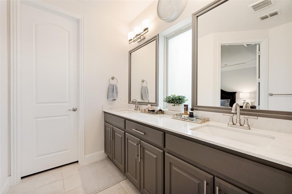 Dual vanity with gray cabinetry, white countertops, and integrated rectangular sinks