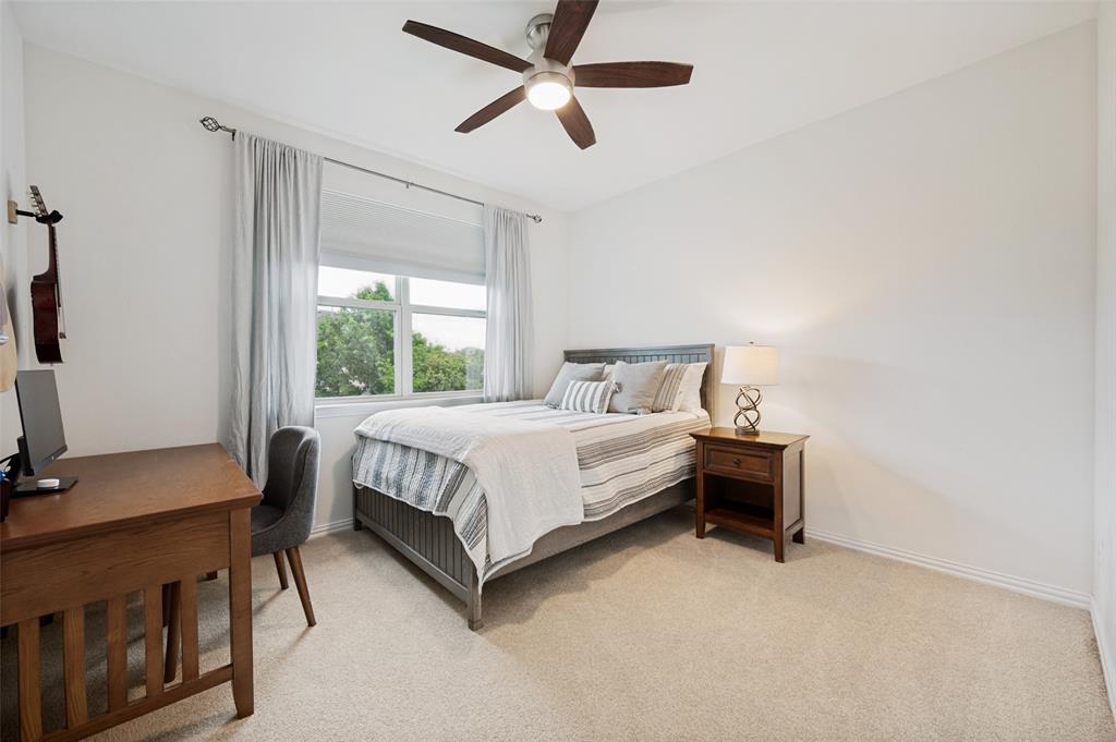 Recessed window with white trim, light-colored carpeting, and a ceiling fan with light fixture