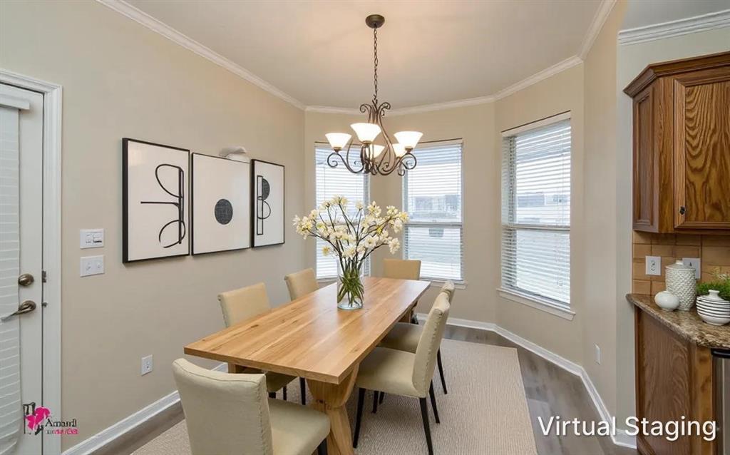 Virtually staged. Bay window configuration with multi-pane windows, crown molding, iron chandelier, and wood-finish flooring