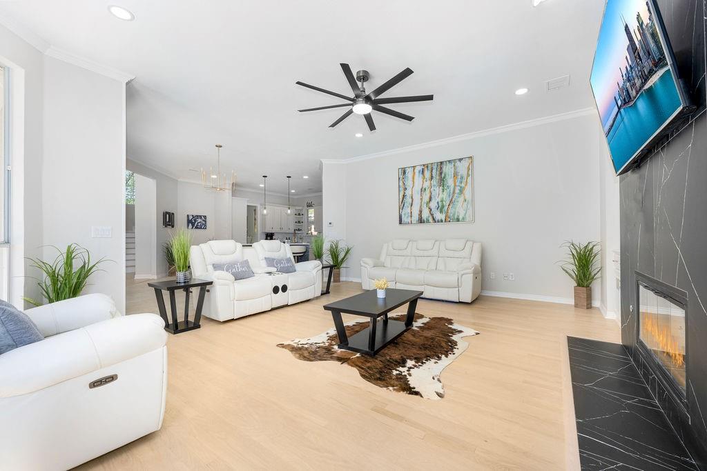 Recessed lighting, wood-finish flooring, and crown molding