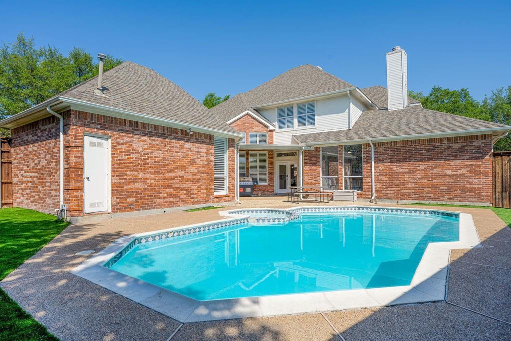 Outdoor swimming pool, brick exterior, multi-story structure, ample patio space, and a white chimney Outdoor swimming pool, brick exterior, multi-story structure, ample patio space, and a white chimney