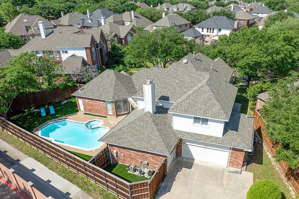 Brick exterior with white siding accents and a multi-level shingle roof