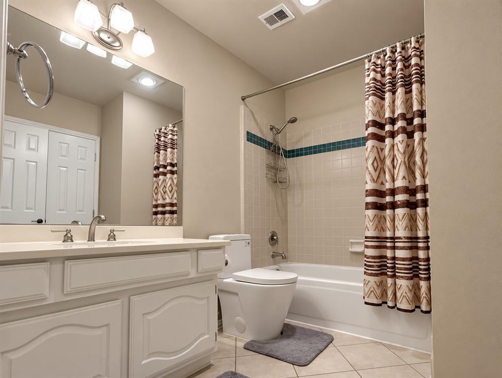 White vanity with integrated countertop, chrome faucet, and rectangular mirror