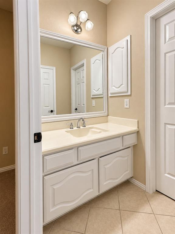 Vanity with an integrated sink, polished chrome faucet, and ample storage