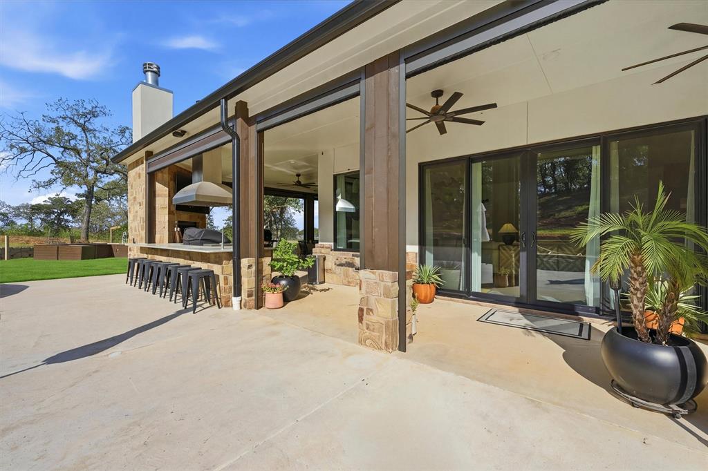Back patio leading to pool - covered porch with automatic screen system