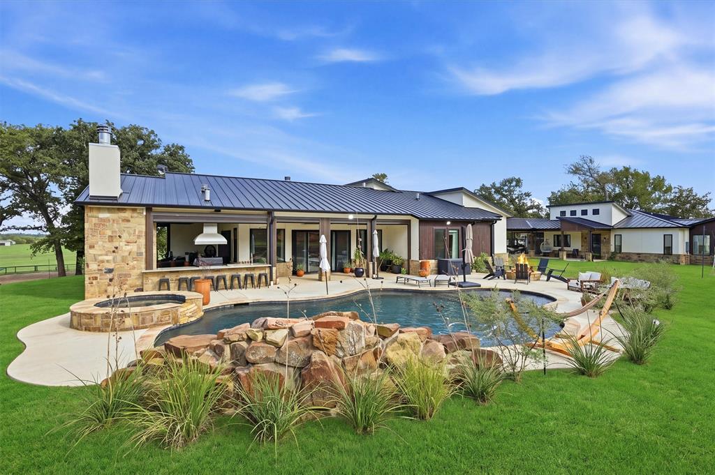 View of hot tub, swimming pool and patio area at rear of the home.  Casita in background.