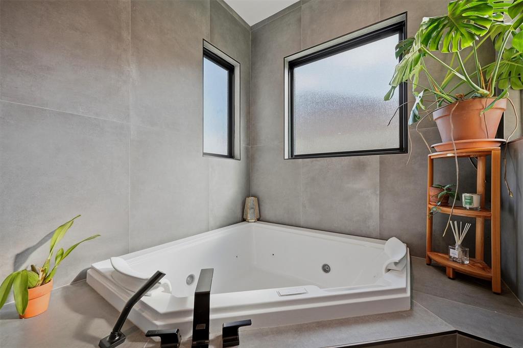Primary bathroom with jetted , soaking corner tub