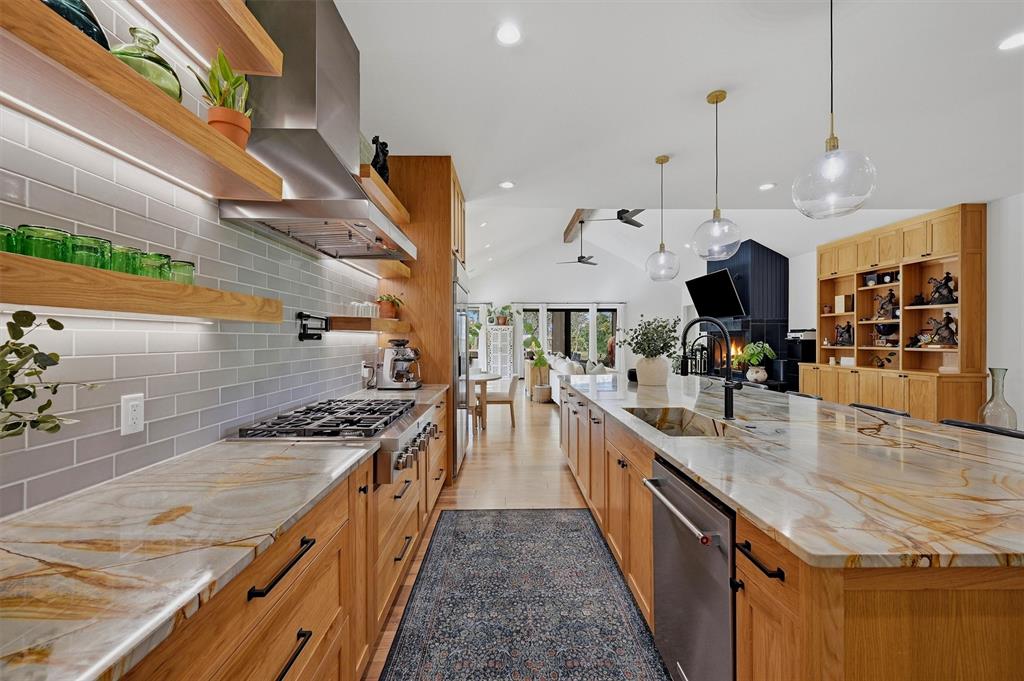 Kitchen- 6-burner commercial grade gas stovetop with vent hood.  Integrated farmhouse sink in island