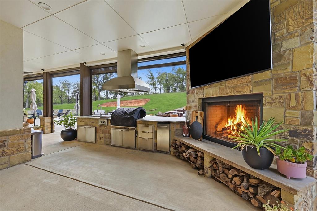 Outdoor kitchen and wood  burning fireplace with gas ignition system