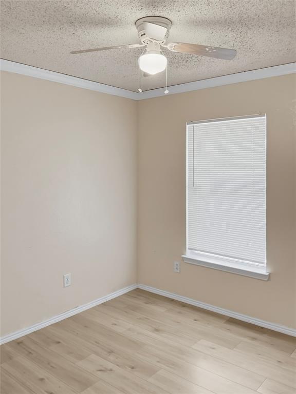 Wood-finish flooring, white window blinds, and a ceiling fan with integrated lighting