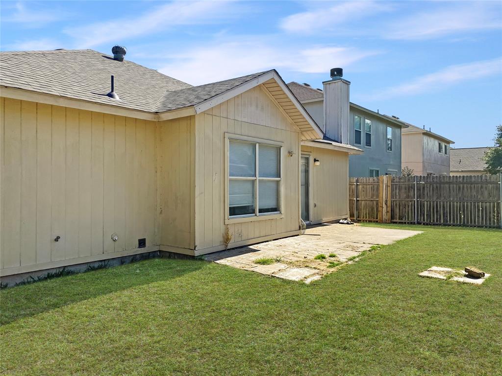 Expansive grass lawn with a concrete patio