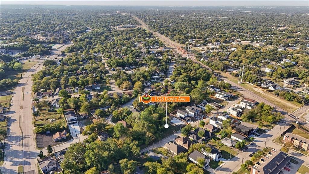 Aerial perspective of a verdant neighborhood with residential properties and arterial roads