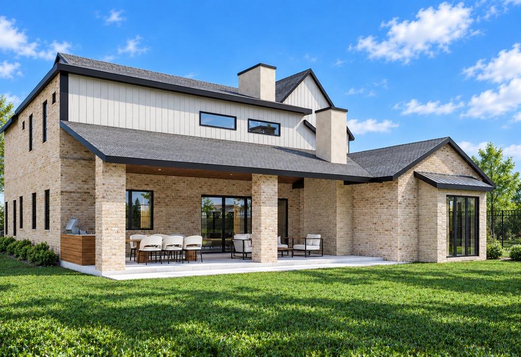 Exterior featuring a light brick facade, board-and-batten siding, covered patio with masonry pillars, built-in outdoor kitchen, and shingle roof