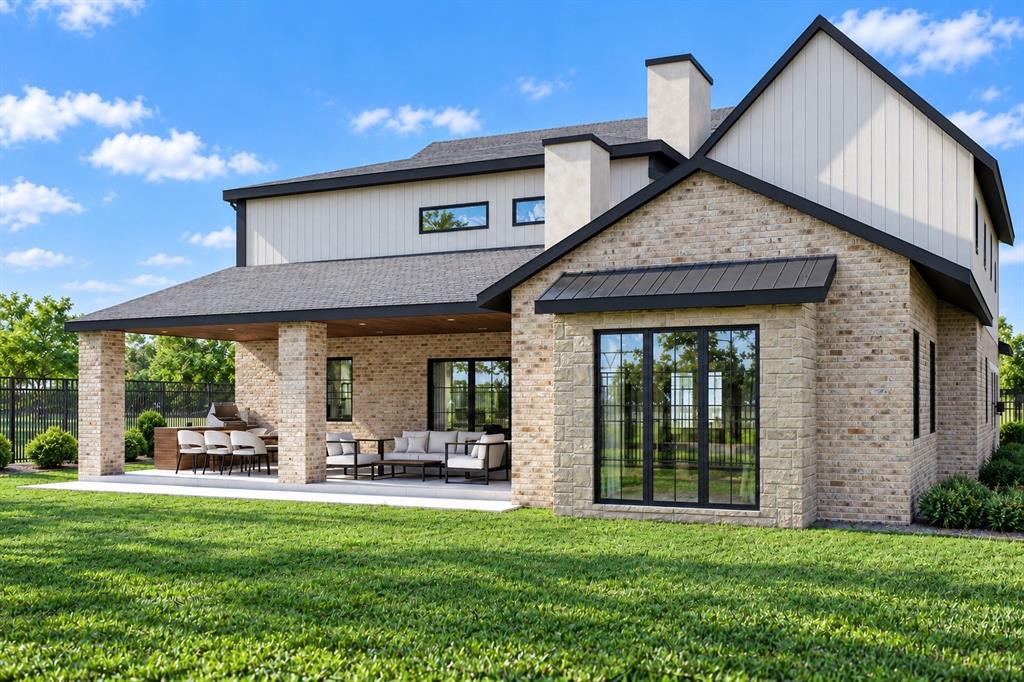 Rear exterior featuring light-toned masonry, vertical siding, a covered patio with recessed lighting, and built-in masonry grill cabinetry