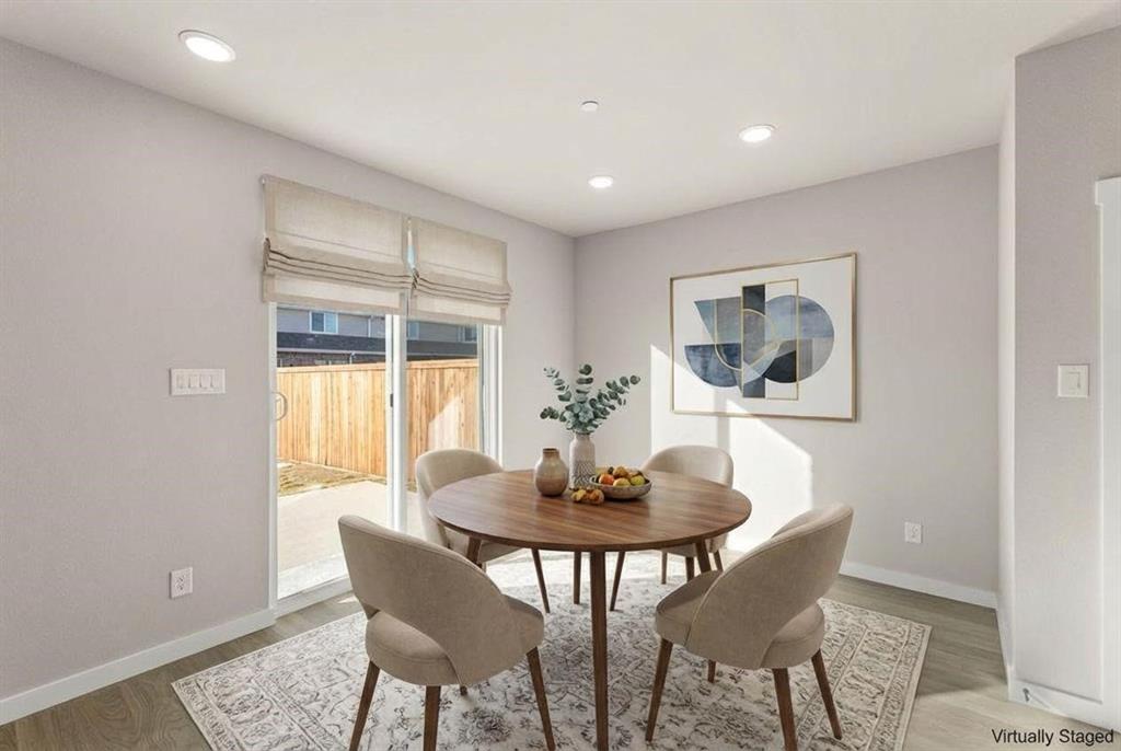 Recessed ceiling lighting, light-tone wood-finish flooring, and a sliding glass door with integrated fabric window shades