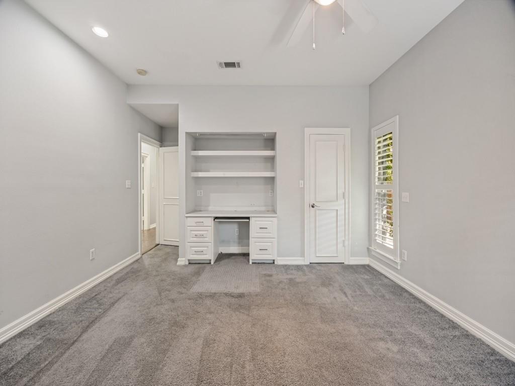 Bedroom with built-in desk and shelving