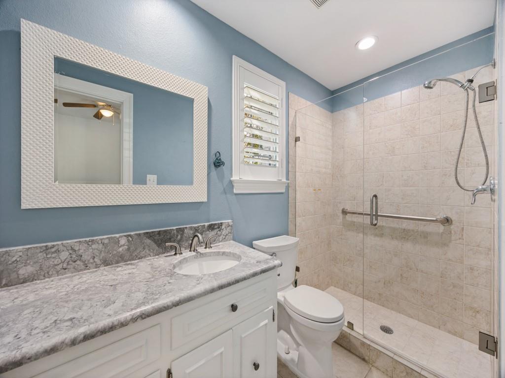 Full bath with walk-in shower and marble vanity