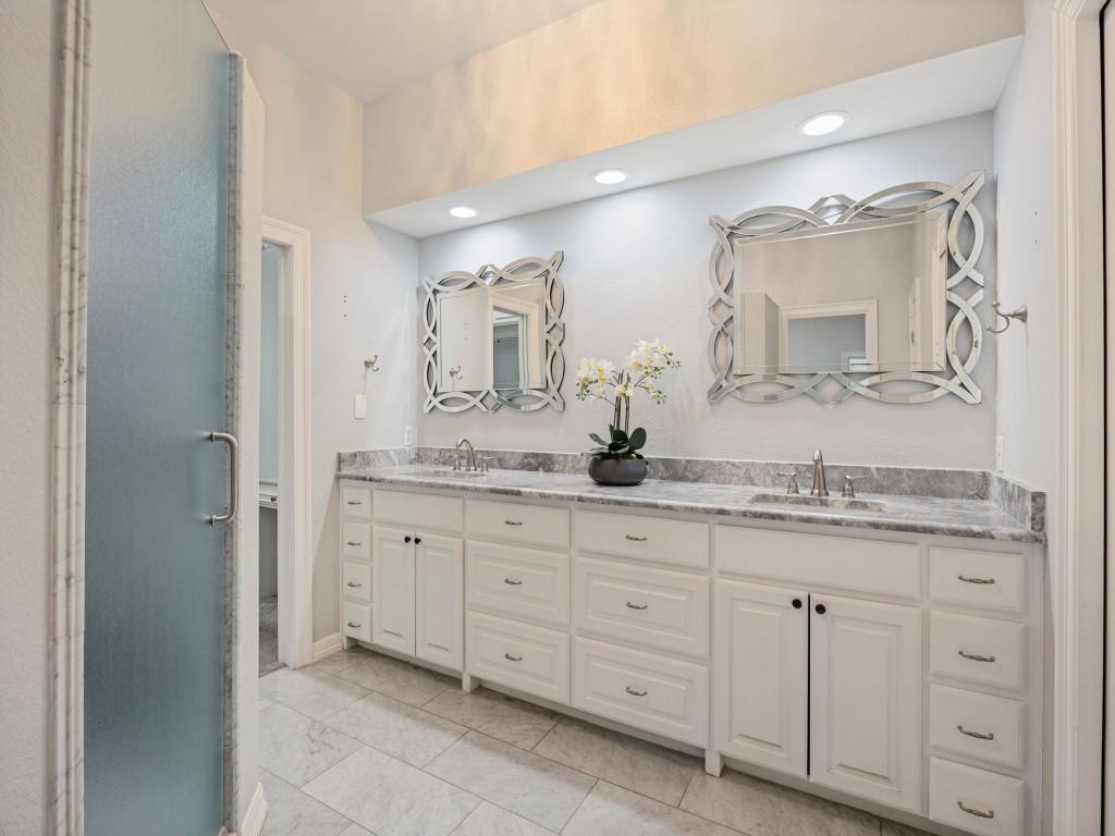 Primary bath with double vanity and marble countertops