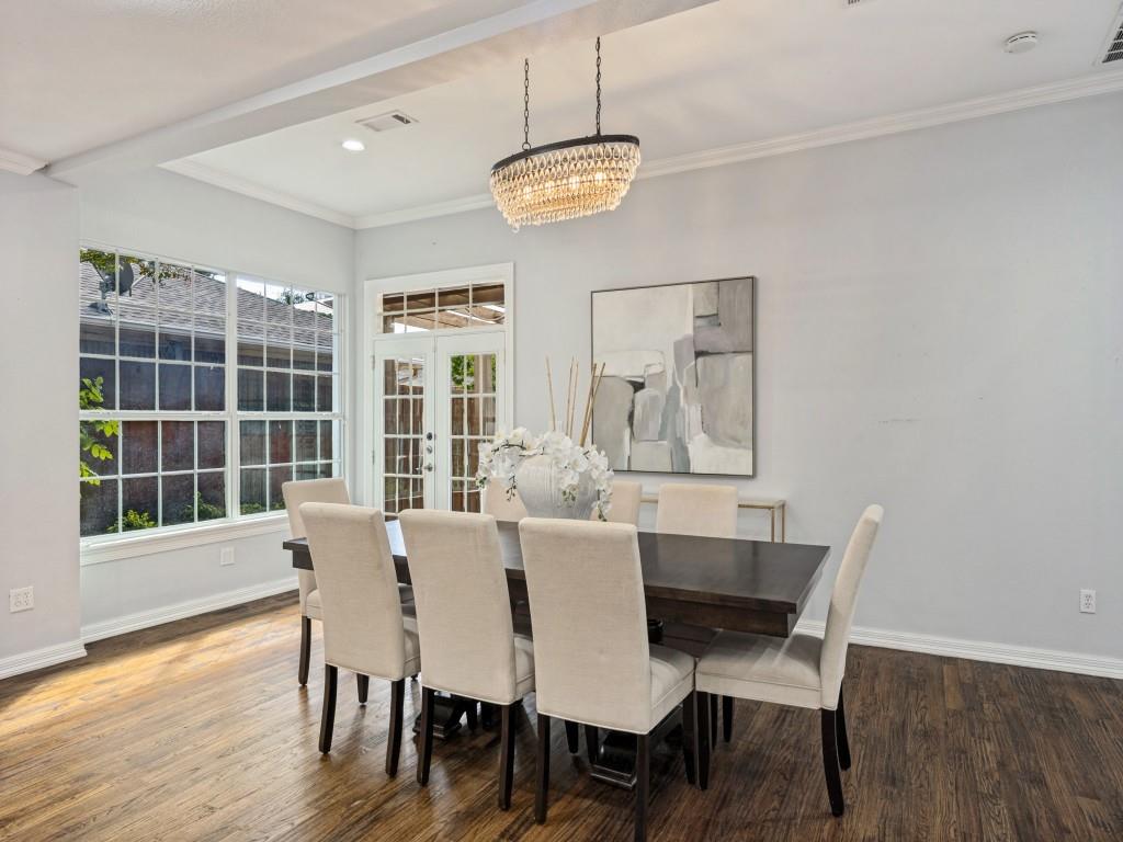 Dining area with statement chandelier and large picture window Dining area with statement chandelier and large picture window