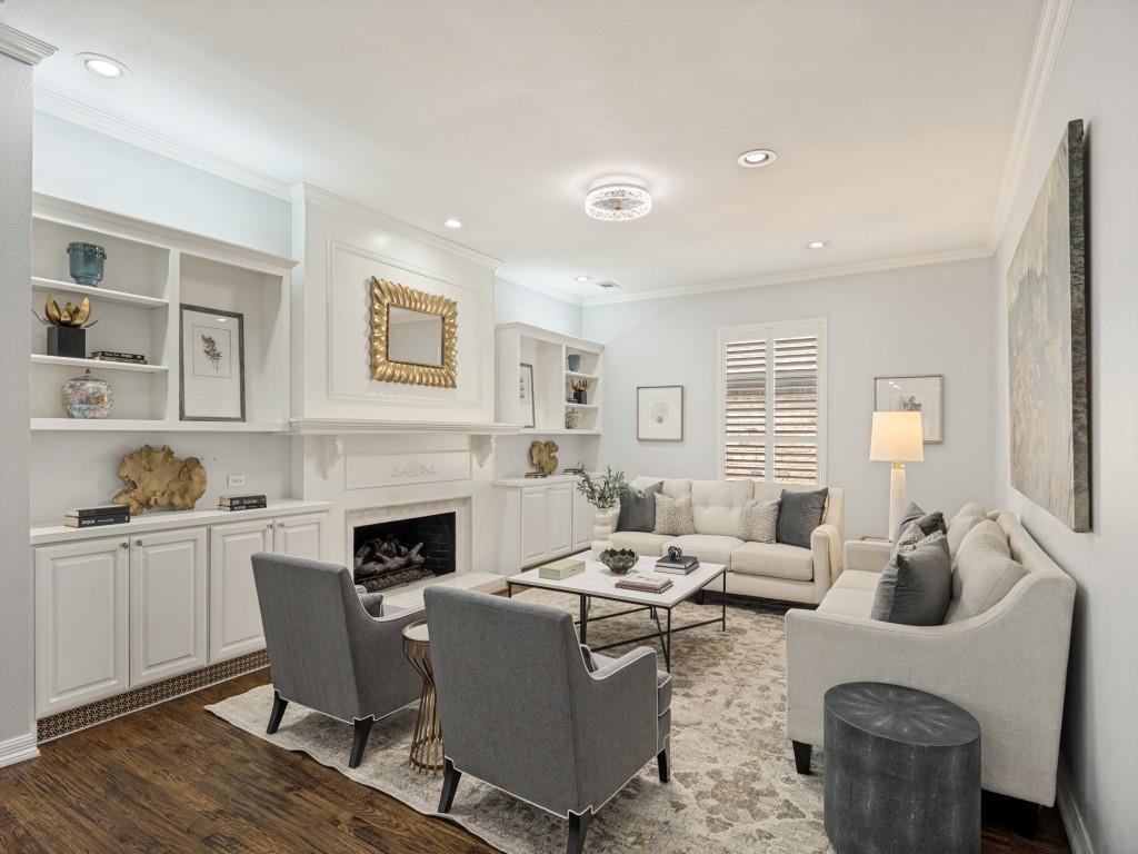 Den with gas-log fireplace flanked by custom built-ins