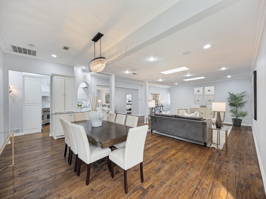 Open-concept living, dining and kitchen with skylights and hardwoods throughout