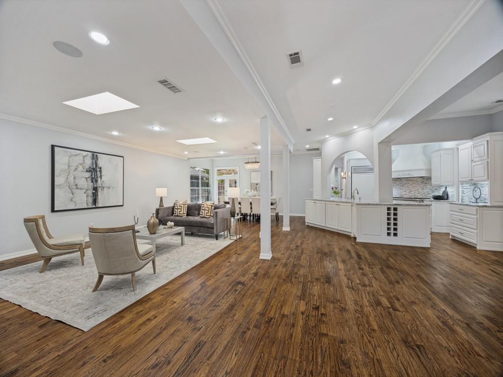 Open-concept living, dining and kitchen with skylights and hardwoods throughout
