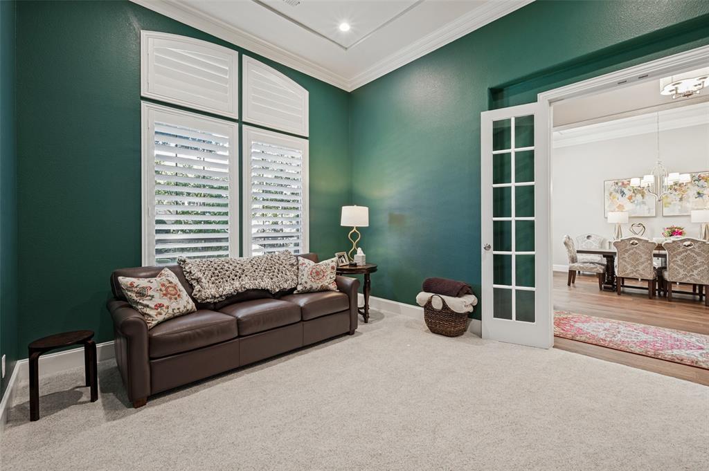 Arch-top window with plantation shutters, crown molding, recessed lighting, and French doors