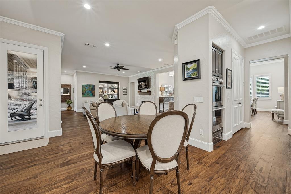Wood-finish flooring throughout, recessed lighting, crown molding, built-in oven, and built-in microwave