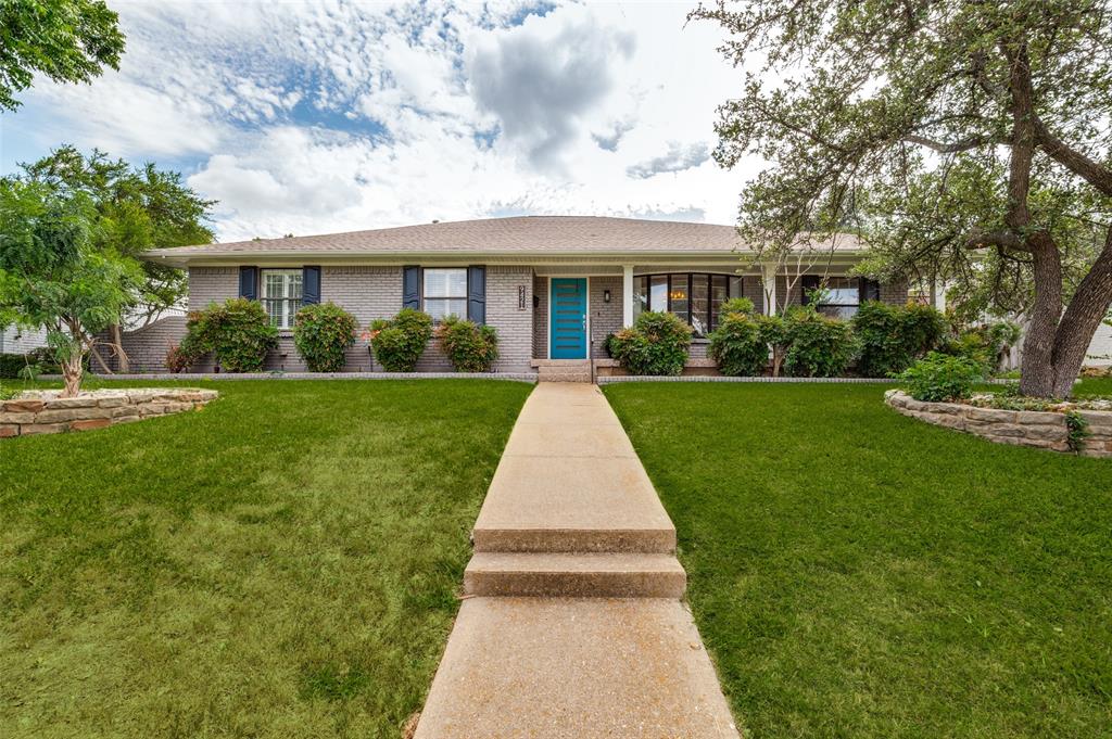 Grey brick exterior with a vibrant turquoise front door