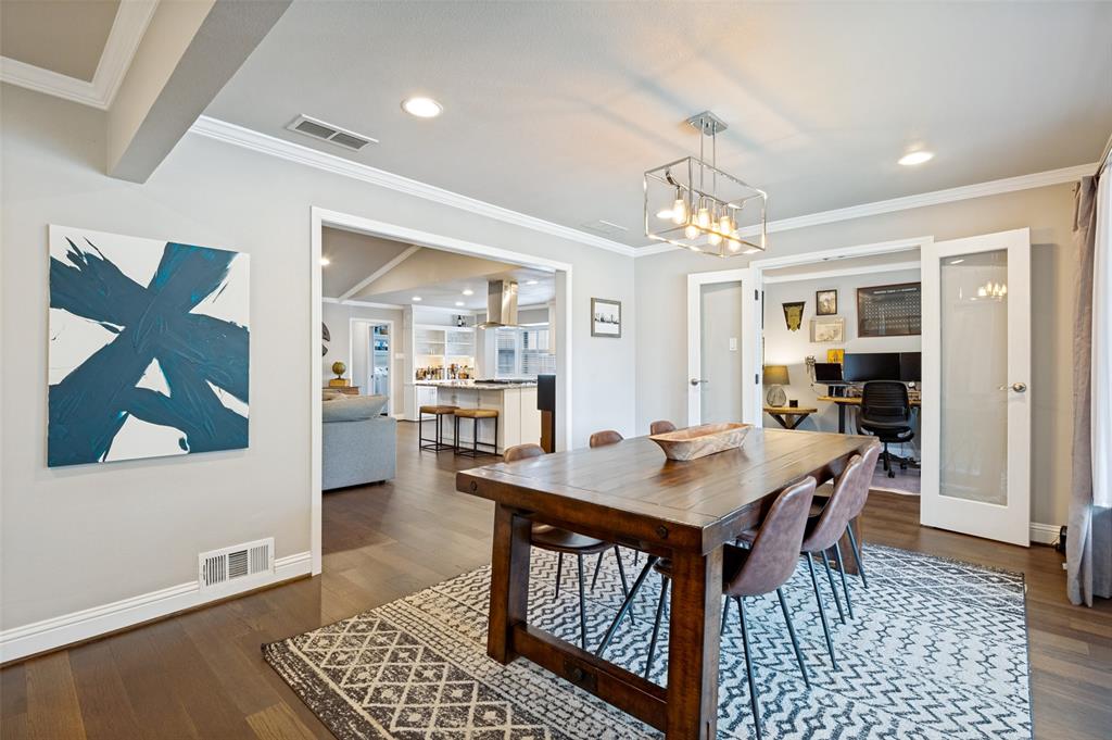 Dining area featuring wood-finish flooring, a contemporary chandelier, recessed lighting, and crown molding