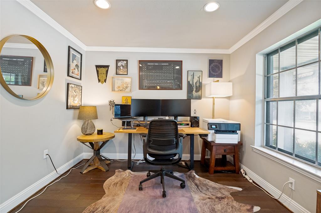 Dedicated office space featuring rich wood-finish flooring and light gray walls