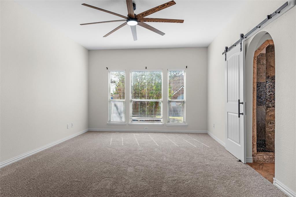 Neutral-toned carpeted flooring complements the light wall color
