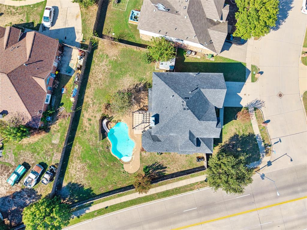 Rear yard featuring a freeform swimming pool with a paved surround and a wood deck