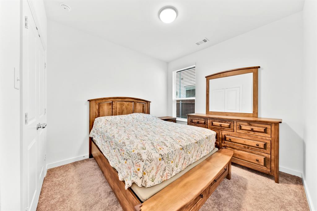 Carpeted flooring, white walls, double-panel closet doors, and recessed lighting