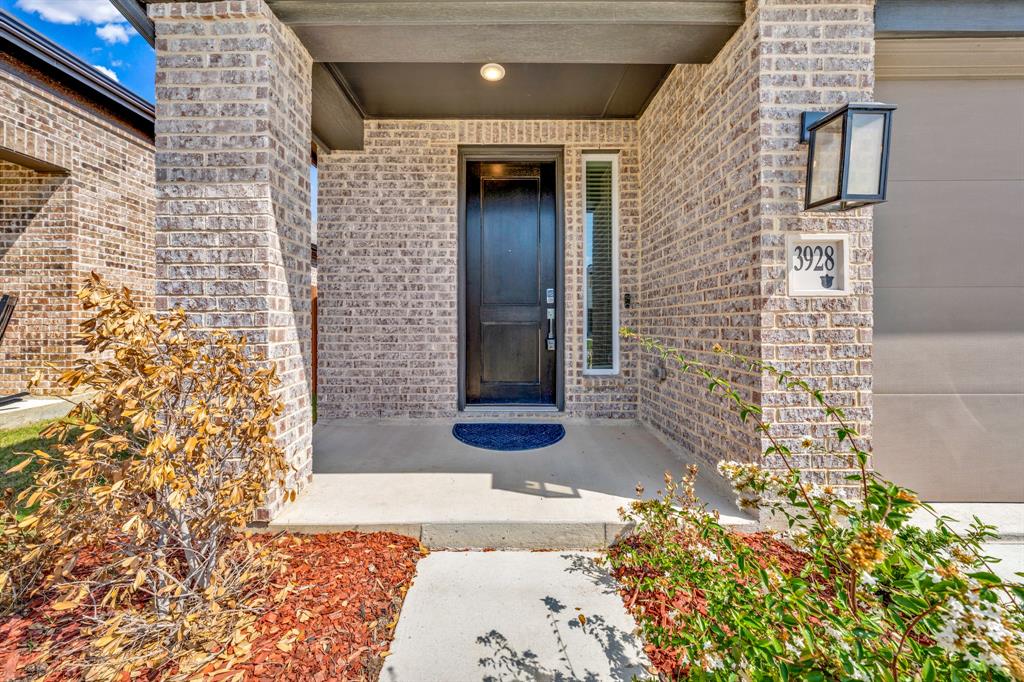 Brick facade with dark trim, covered porch, and a dark front entry door