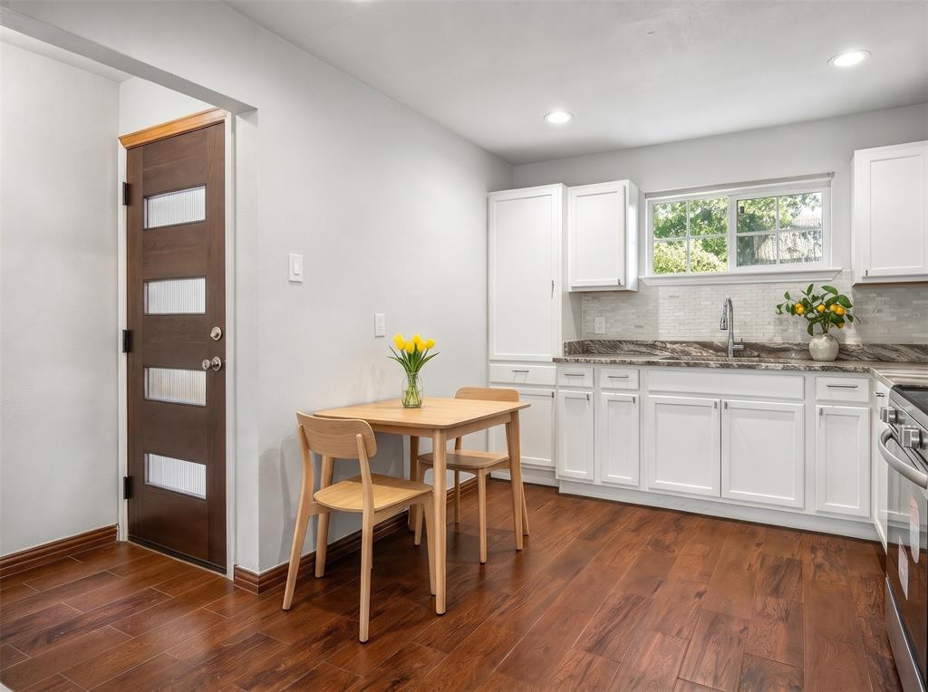 Space for Dining in Kitchen too! Note pretty glass tile backsplash - Virtually staged