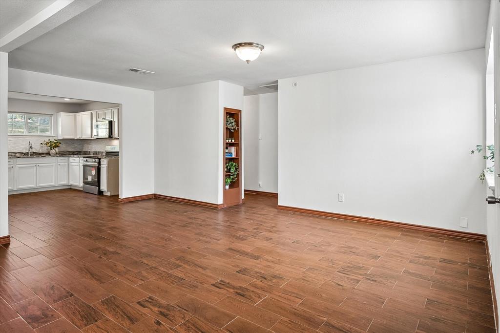 Tile with Wood look flows through Living to Kitchen