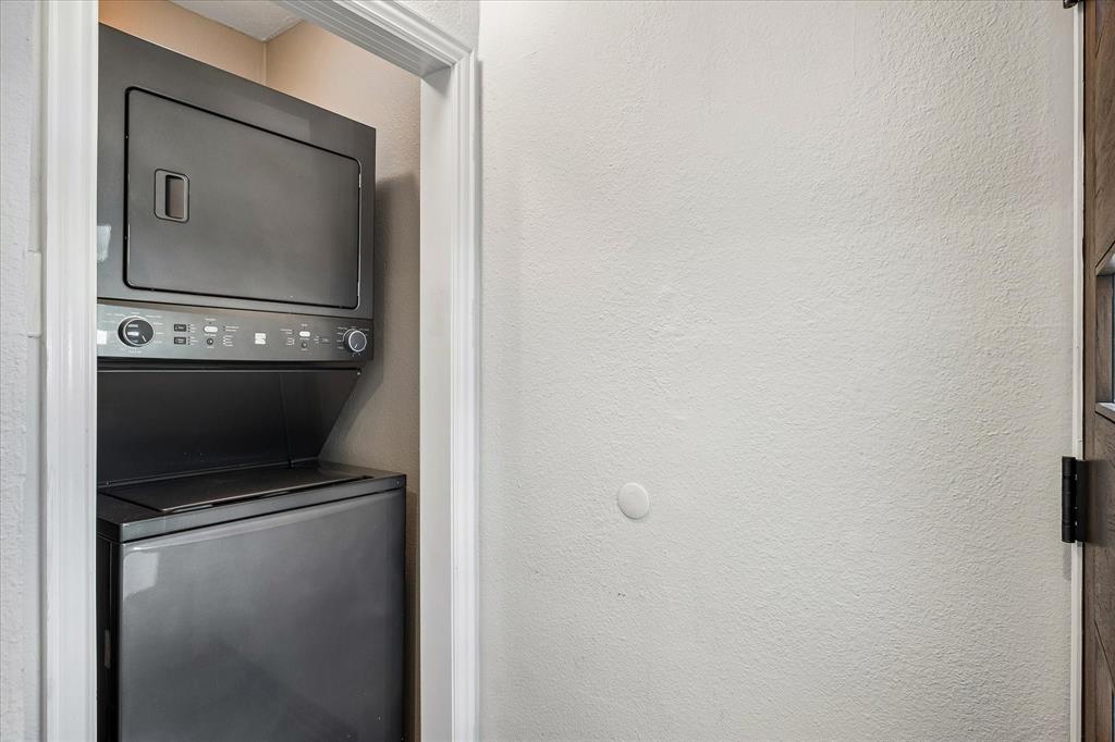 Stacked Washer Dryer Sits Opposite Back Door