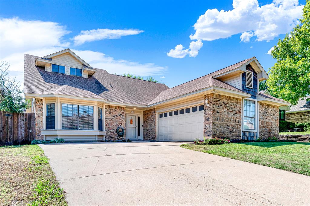 Welcome to 2722 Strother in Garland! Textured brickwork, cedar shake accents, and steep gables create a warm, inviting front facade under bright blue skies. Arriving home feels instantly comforting as you pull up the wide driveway to your peaceful sanctuary.